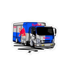 May include: A sticker featuring a stylized illustration of a Red Bull delivery truck. The truck is primarily white, blue, and red, with the Red Bull logo prominently displayed. The truck has a lowered suspension and custom wheels.