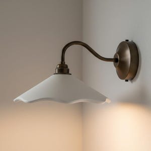 May include: A set of three ceramic mugs with a speckled, matte finish in cream, light brown, and dark brown. Each mug has a simple, minimalist design and a rounded handle.