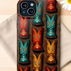 May include: A phone case featuring a repeating pattern of colorful cowboy boots. The boots are in shades of red, orange, teal, and gold, with decorative stitching. The case has a glossy finish and a camera cutout.