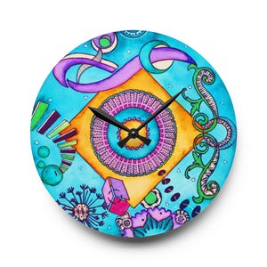 May include: A round wall clock with a vibrant, abstract design. The clock face features a turquoise background with a central orange square and a pink and yellow circular design. Purple ribbon-like shapes and green floral elements add detail.