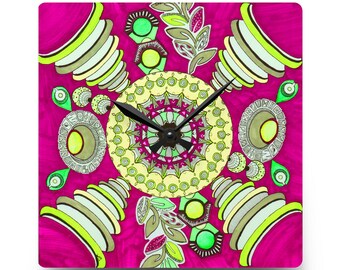 May include: Square wall clock with a vibrant magenta background and a colorful, abstract design. The clock face features a central mandala pattern in yellow and green, surrounded by geometric and floral elements. Black clock hands indicate the time.