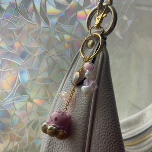 May include: A set of three ceramic mugs with a speckled, matte finish. The mugs are in shades of cream, light gray, and dark gray. Each mug has a simple, minimalist design, perfect for coffee or tea.