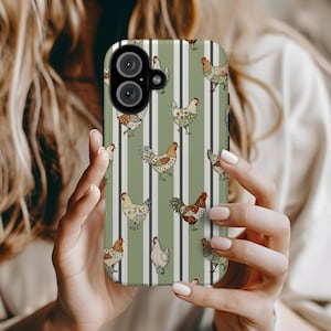 May include: A phone case featuring a repeating pattern of chickens in various colors and patterns against a background of vertical stripes in olive green and white. The case has a camera cutout and is held by a person.
