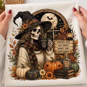 May include: A white fabric print featuring a skeleton wearing a witch hat and a plaid scarf, holding a mug labeled 'WITCHES GET STUFF DONE'. The scene includes pumpkins, a lantern, a sign reading 'PUMPKIN SPICE COZY NIGHTS SPOOKY VIBES HAPPY HAUNTS', and books.