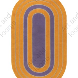 May include: An oval-shaped rug with a layered design. The rug features a central purple section surrounded by concentric bands of orange. The design is simple and modern, suitable for various interior styles.