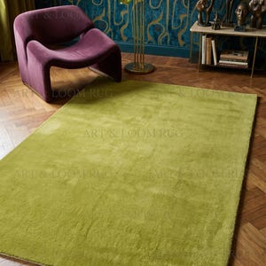May include: A large, rectangular, lime green rug with a plush texture. The rug is placed on a hardwood floor, with a purple chair and a multi-colored glass lamp in the background. The rug is a key element in the room's decor.