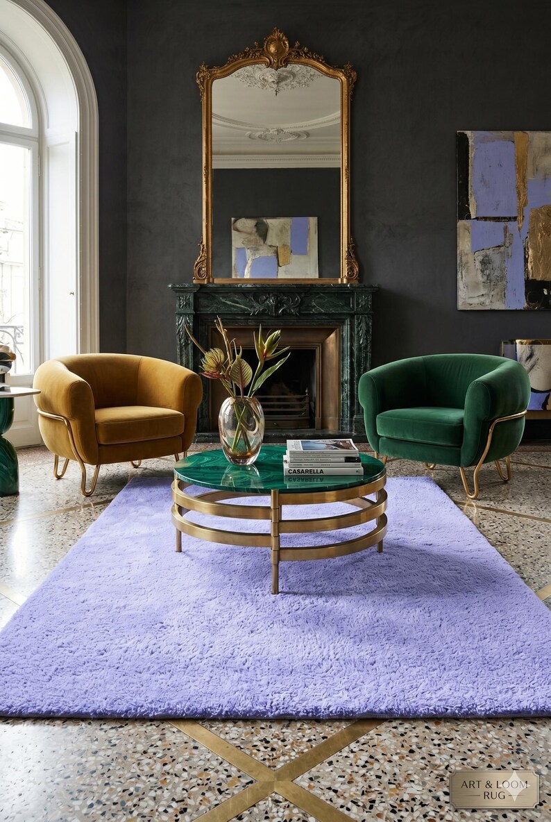 May include: A luxurious living room setting featuring a lavender rug, two velvet armchairs in gold and green, and a round coffee table with a green top and gold base. A fireplace and ornate mirror complete the elegant decor.