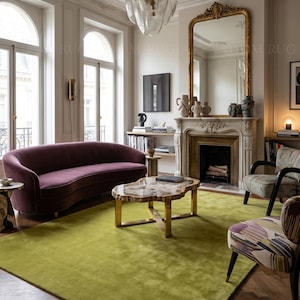 May include: A living room featuring a large, lime green rug, a curved purple sofa, and two patterned armchairs. A gold-framed mirror and a fireplace add elegance. A unique coffee table sits in the center.