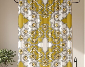 May include: A decorative shower curtain with a repeating pattern of gold, white, and gray floral and geometric shapes. The curtain is hanging in a bright bathroom with a window, plants, and a wooden stool.