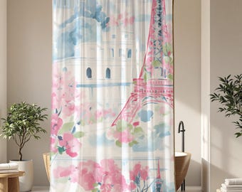 May include: A watercolor-style shower curtain featuring the Eiffel Tower and a building with arches, set against a backdrop of blue skies and pink flowers. The curtain adds a touch of Parisian charm to any bathroom.