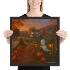 May include: Framed artwork depicting an autumnal scene with a white house, pumpkins, and a friendly ghost. The art uses a warm colour palette of orange, brown, and yellow. The scene includes a path, fence, and trees, with the text "Interior Prints".