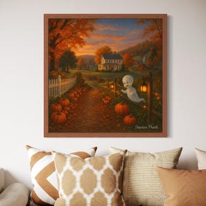 May include: A framed print shows a Halloween scene with a white ghost, pumpkins, and a house. The artwork features a path lined with pumpkins, leading to a house with a warm glow, set against a backdrop of autumn foliage.