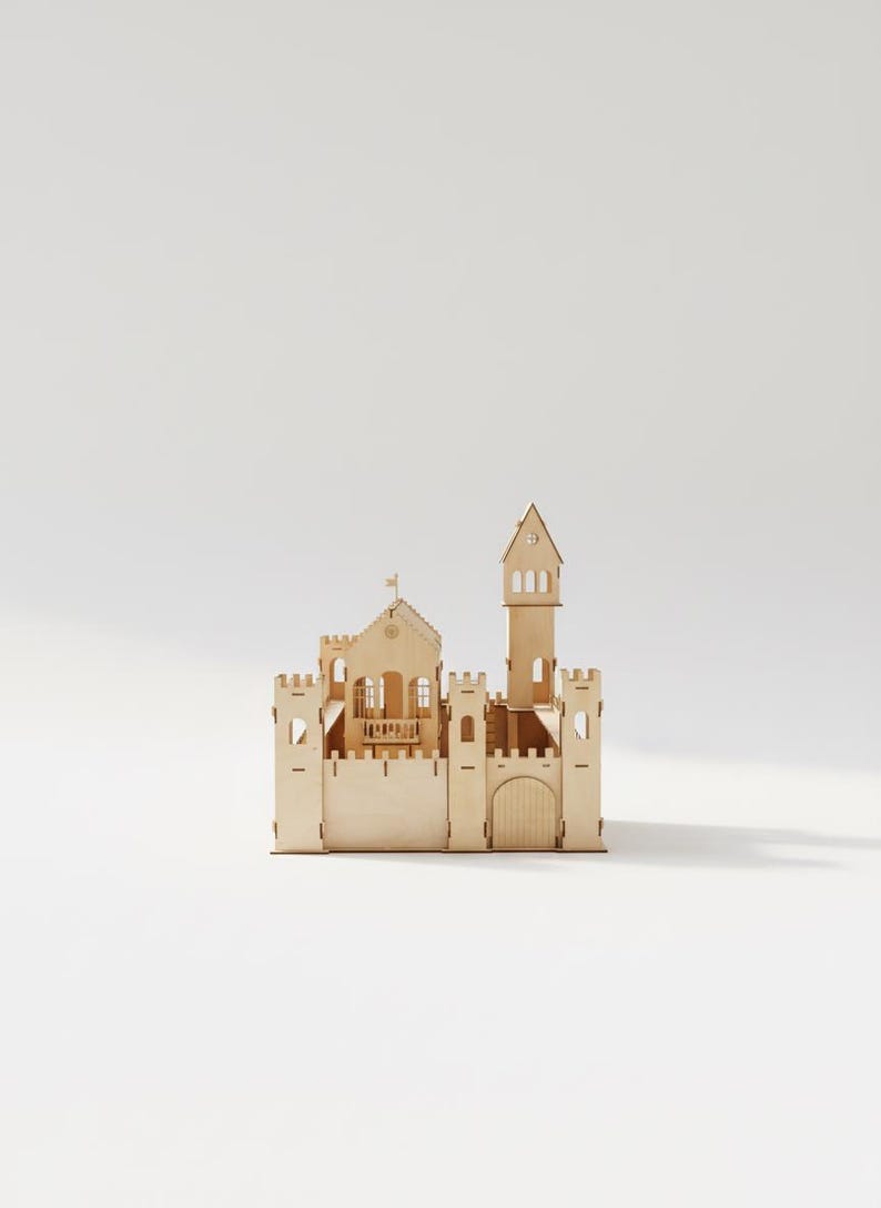 May include: A wooden castle model with a tall tower, arched doorway, and multiple turrets. The light-colored wood construction features detailed cutouts for windows and decorative elements. A small flag is atop the main building.