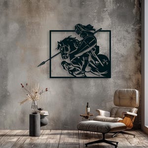 May include: Black metal wall art depicting a knight on horseback, framed within a square. The knight is holding a spear and shield, mounted on a rearing horse. The artwork is mounted on a textured gray wall.