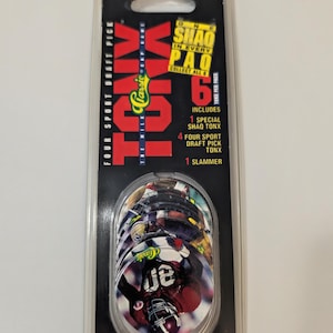 Könnte beinhalten: Eine versiegelte Packung mit "TONX" Classic Games Sammelsportdiscs. Die Verpackung ist schwarz mit rotem und grünem Text und enthält sechs Discs mit Footballspielern. Der Text lautet "FOUR SPORT DRAFT PICK" und "ONE SHAO IN EVERY PAO".