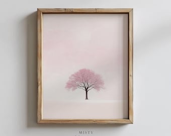 May include: A framed wall art print featuring a single tree with pink foliage centered against a pale, soft pink background. The artwork is enclosed in a light-toned wooden frame with a visible grain texture, creating a clean and simple display.