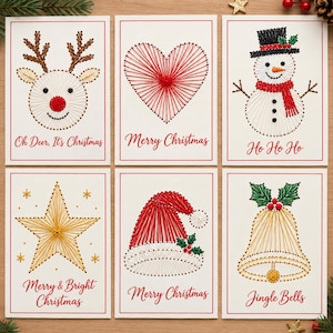 May include: Six white greeting cards featuring string art designs of a reindeer, heart, snowman, star, Santa hat, and bell. Each card includes red cursive text: Oh Deer, It's Christmas, Merry Christmas, Ho Ho Ho, Merry & Bright Christmas, and Jingle Bells.