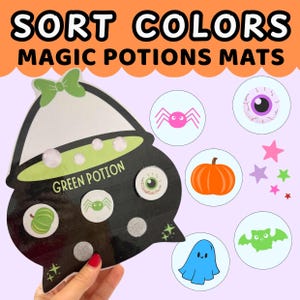 May include: A Halloween-themed educational game with the text "SORT COLORS MAGIC POTIONS MATS." The game features a black cauldron with the words "GREEN POTION" and various colorful circular images of a spider, eye, pumpkin, ghost, and bat.