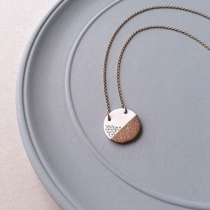 Tal - Cream and Gold Ceramic Pendant Necklace; Handmade Round Clay, Brass Metallic Stripe & Grey Dots (Sautoir Céramique Or) by InfinEight