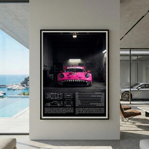 May include: Framed print featuring a pink race car with a shark-themed front design, positioned in a garage setting. The print includes technical diagrams and specifications. The car displays the number 72.