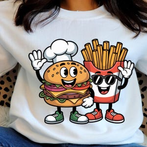 May include: White sweatshirt featuring a cartoon burger wearing a chef's hat and a smiling carton of fries wearing sunglasses. The burger has a smiling face and is waving. The fries are waving too. The burger and fries are wearing shoes.