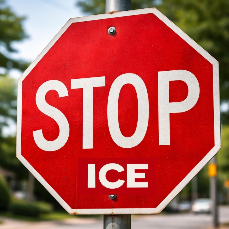 May include: A red octagonal stop sign with the word "STOP" in large white letters. Below, a white rectangle reads "ICE". The sign is mounted on a metal pole, with a blurred background of trees and a street.