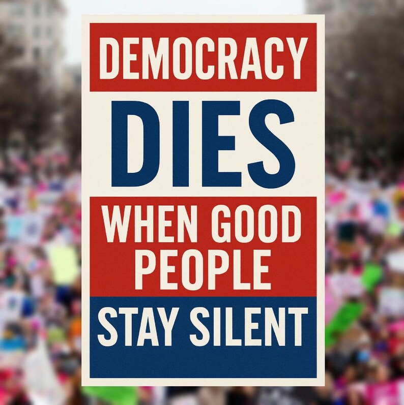May include: A poster with the words "DEMOCRACY DIES WHEN GOOD PEOPLE STAY SILENT" in bold white and blue text against a red and cream background. The background is blurred, suggesting a crowd.