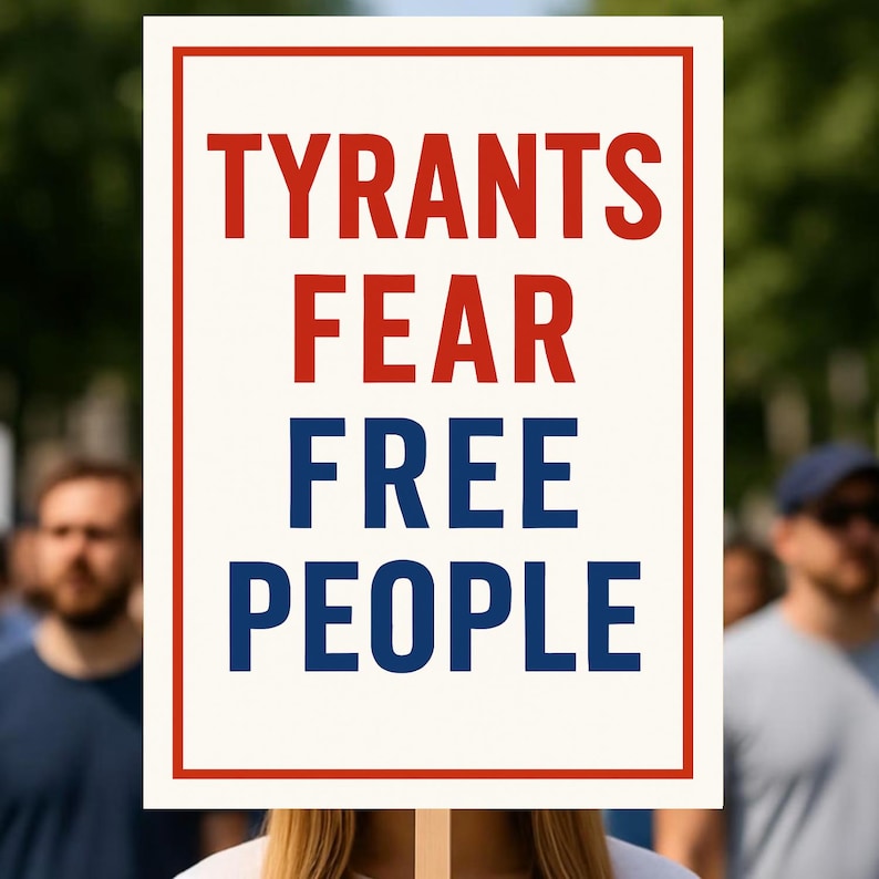 May include: A white sign with a red border and the words "TYRANTS FEAR FREE PEOPLE" in red and blue block letters. The sign is held up in front of a crowd of people.