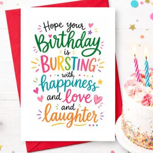 May include: A birthday greeting card with a red envelope. The card has the words "Hope your Birthday is BURSTING with happiness and love and laughter" in colorful lettering. A birthday cake with lit candles is in the background.