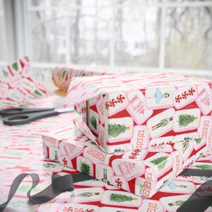 May include: Wrapping paper featuring a repeating pattern of Christmas-themed illustrations on a red background. The design includes nutcrackers, Christmas trees, ballerinas, pink pagodas, and red and white peppermint candies in white frames.