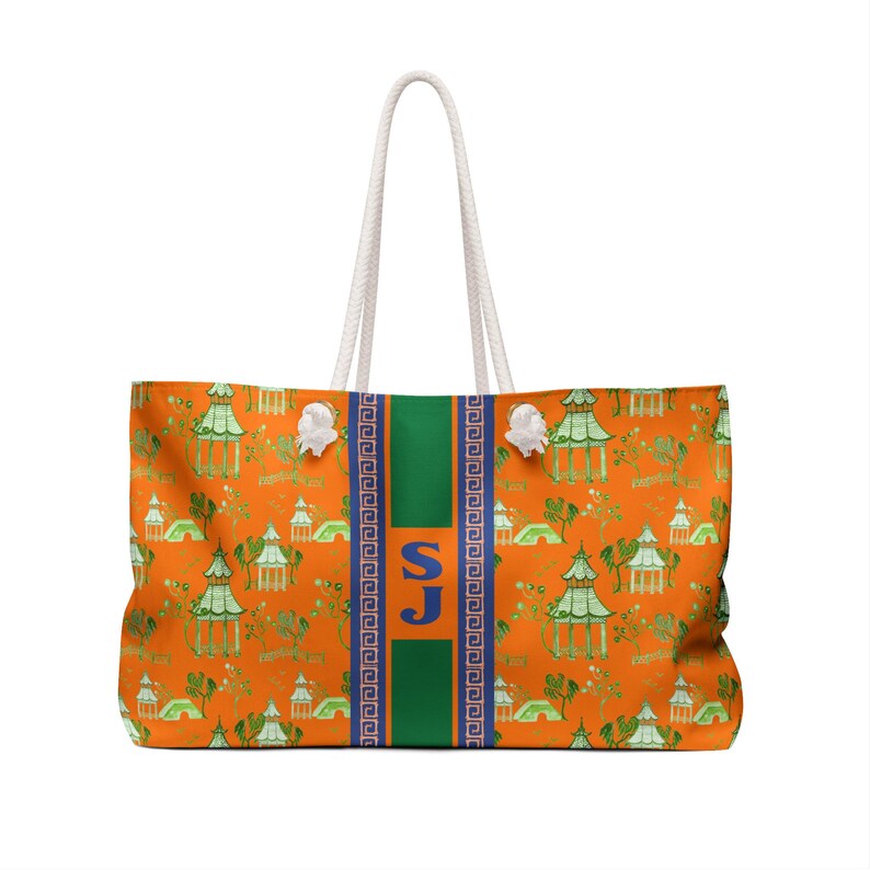 May include: Orange tote bag with a green and white pagoda pattern. The bag has a green stripe down the center with the letters "SJ" in blue. The handles are white rope.