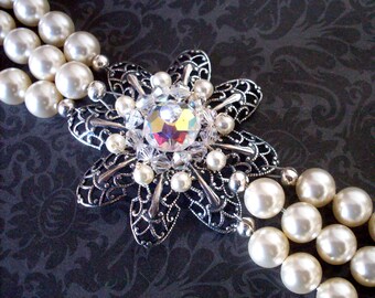 Cream pearl bracelet, triple strand, filigree bracelet, antiqued silver flower centerpiece, Swarovski crystal beaded filigree jewelry