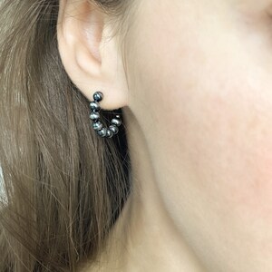 Dark Sterling silver Open hoop earrings, ball hoop earrings on a female model inspired by Navajo Pearls