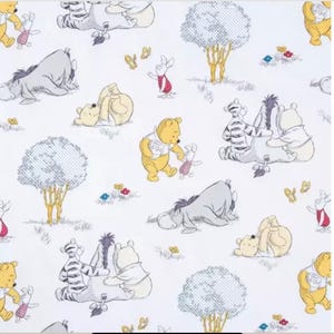 May include: White fabric with a repeating pattern of Winnie the Pooh characters, including Pooh Bear, Piglet, Eeyore, and Tigger. The design includes trees, butterflies, and flowers. The text "Winnie the Pooh Print #1" is at the bottom.