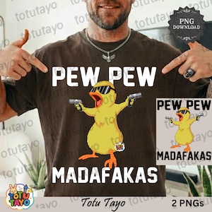 May include: Brown t-shirt with the text "PEW PEW MADAFKAS" and a cartoon yellow duck wearing sunglasses and holding two guns. A smaller image of the duck is on the right. The brand name "Totu Tayo" is at the bottom.