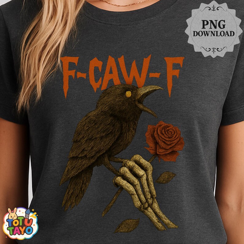 May include: Dark gray t-shirt featuring a crow illustration with the text "F-CAW-F". The crow is holding a rose in a skeletal hand. The design has orange and brown tones.