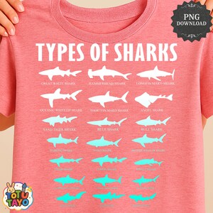 May include: Coral-colored t-shirt featuring the text "TYPES OF SHARKS" above illustrations of various shark species. The shirt displays shark silhouettes in white and turquoise, including Great White, Hammerhead, and Blue Sharks.