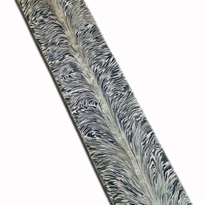 May include: A rectangular, marbled-patterned object with a feather-like design in shades of gray and black. The object has a smooth, polished surface and a slightly rounded edge. The overall aesthetic is elegant and artistic.