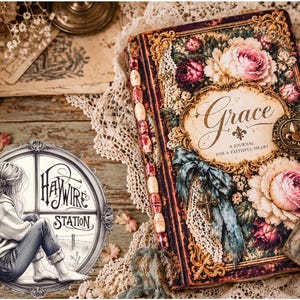 May include: A rectangular journal titled Grace: A Journal for a Faithful Heart, featuring a floral cover with pink and dark red roses, gold filigree borders, a blue ribbon, a small metal cross, and a spine decorated with cream and red beads.