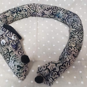 Dachshund draft stopper; draught excluder; Dog light blocker; pre-filled; made of gray and black floral batik fabric