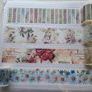 Op de afbeelding: Vier rollen decoratieve washi tape met bloemen- en vintage-ontwerpen. De tapes hebben verschillende patronen, waaronder bloemen, bladeren en tekst. De tapes zijn allemaal in tinten bruin, groen en wit.