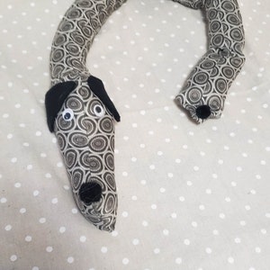 Dachshund draft stopper; draught excluder; Dog light blocker; pre filled; made of tough gray upholstery fabric with circle designs