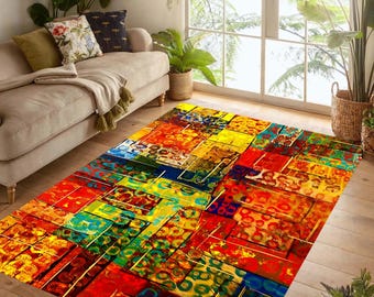 May include: A rectangular area rug with a vibrant abstract design. The rug features a patchwork of colorful blocks in shades of red, yellow, blue, and green. The rug is placed on a wooden floor in a living room setting.
