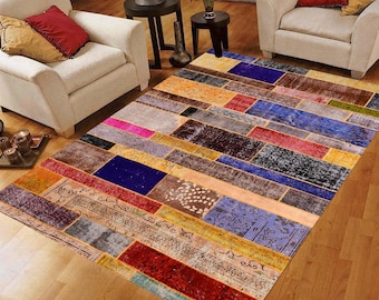 May include: A rectangular area rug with a patchwork design. The rug features a variety of colors including red, blue, brown, and yellow. The rug is made of a soft material and is suitable for a living room or bedroom.