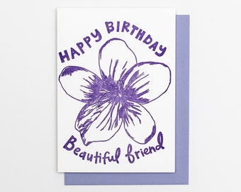 May include: Purple greeting card with a white background and a purple flower illustration. The card reads "Happy Birthday Beautiful Friend".
