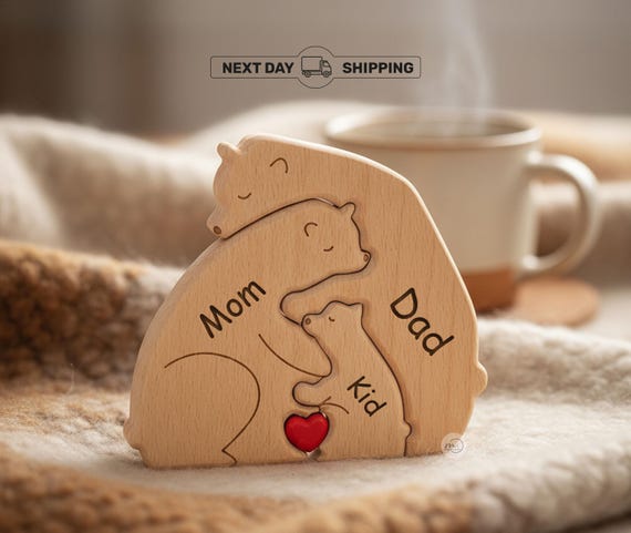 A family of hand-cut hugging bears arranged to spell a baby's name — the 'bear hug' concept makes it emotionally resonant nursery art AND a puzzle.