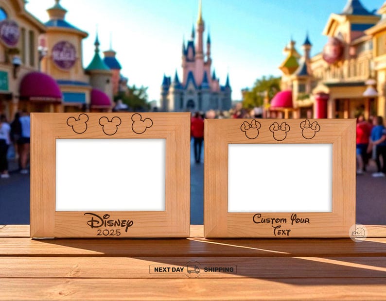 May include: Two wooden picture frames with Mickey Mouse and Minnie Mouse designs. The left frame has "Disney 2025" text, and the right frame has "Custom Your Text". The frames are on a wooden surface with a blurred theme park background.