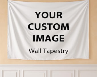 May include: A white wall tapestry with the text "YOUR CUSTOM IMAGE" in large black letters. Below the text is "Wall Tapestry" in a smaller font. The tapestry is hanging on a beige wall above a white wainscoting.