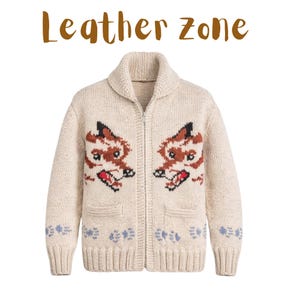 May include: Cream-coloured zip-up sweater featuring fox face designs. The sweater has a shawl collar, two front pockets, and blue floral accents on the cuffs and hem. The text "Leather Zone" is above the sweater.