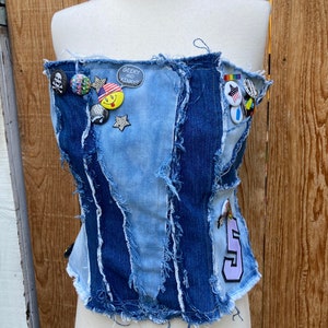 Recycled stretch patchwork bleached denim corset with all over frayed edges, patch, pin and button details SZ M